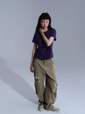 Khaki distressed washed cargo pants with ripped knee details and relaxed wide-leg streetwear fit shown from the front