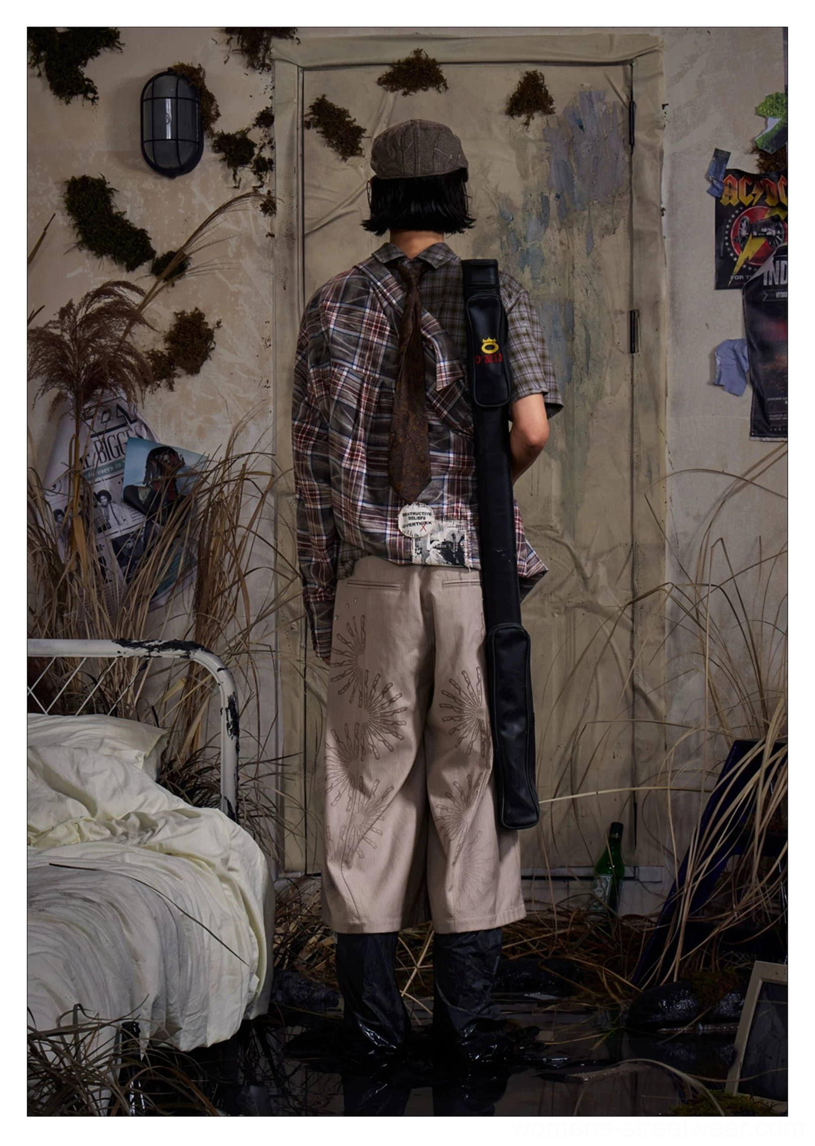 Back three-quarter outfit view of khaki cropped wide-leg trousers with sunburst embroidery details
