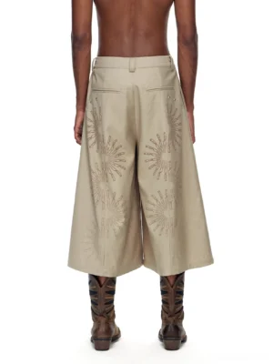 Back view of khaki embroidered cropped wide-leg streetwear trousers with sunburst detail on pant legs