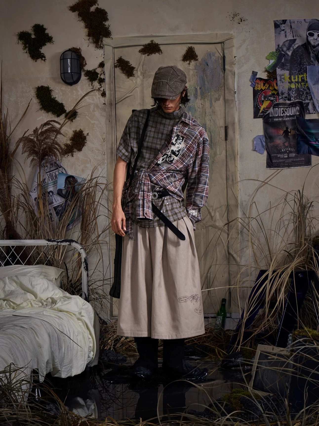 Khaki embroidered pleated cropped wide-leg streetwear trousers styled on a model in a retro bedroom
