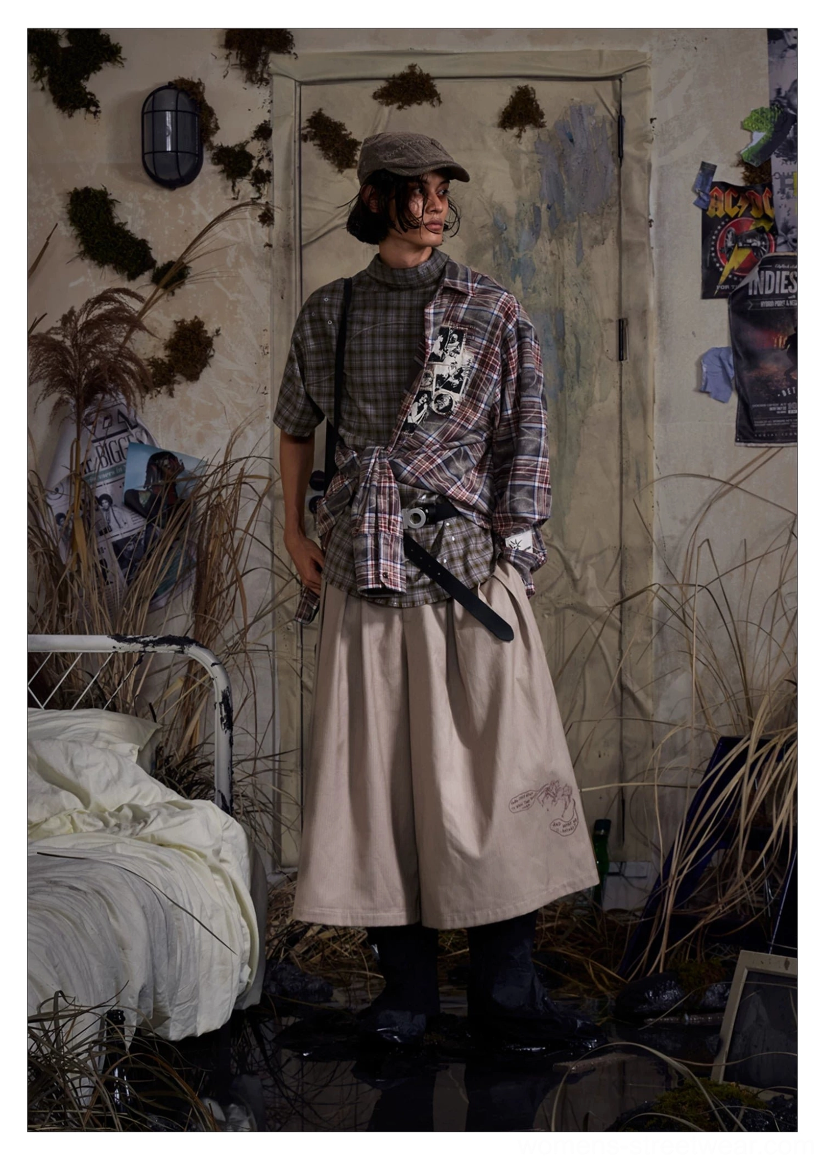 Khaki pleated cropped wide-leg streetwear trousers showing loose structured silhouette from the front