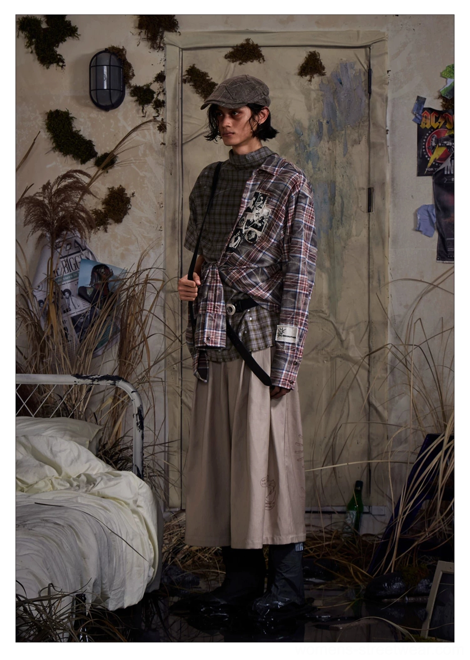 Three-quarter view of khaki embroidered cropped wide-leg trousers styled with plaid shirt and boots