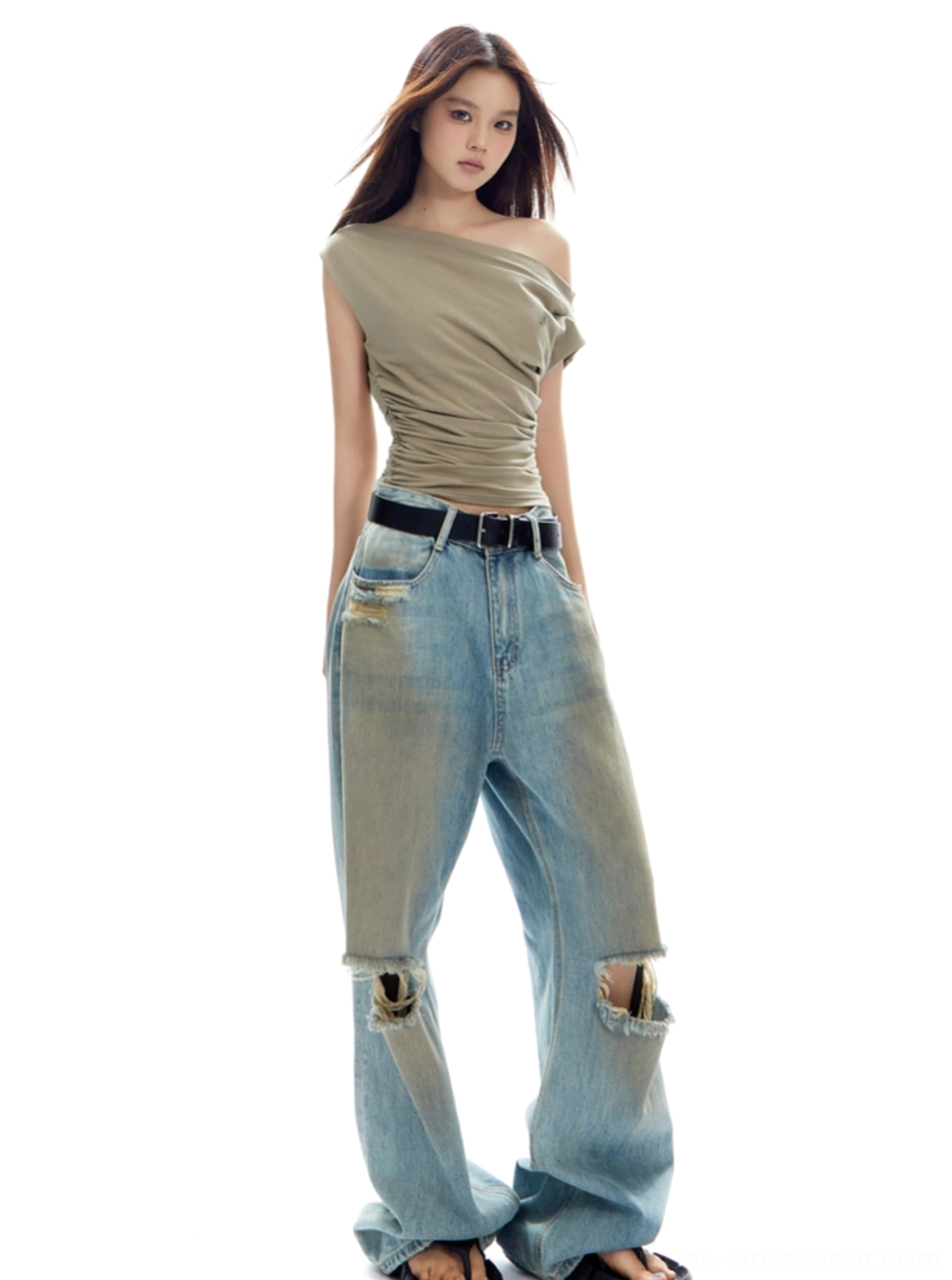 Khaki fitted off-shoulder ruched top paired with ripped wide-leg jeans for a contemporary women's streetwear outfit