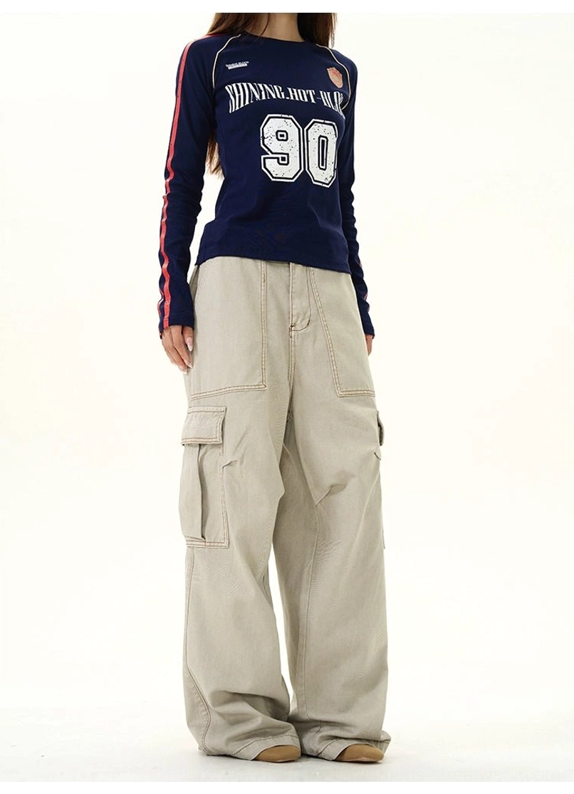 Back view of khaki full-length wide-leg cargo pants with multiple side pockets and relaxed streetwear silhouette