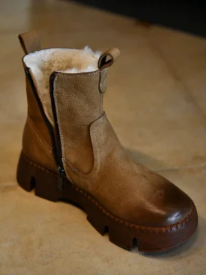 Khaki fur-lined brown winter platform boots with distressed leather upper, chunky lug sole, side zipper, and plush shearling collar