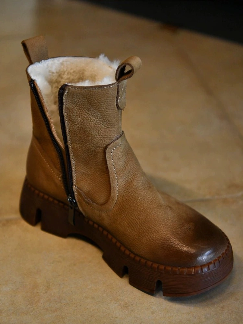 Khaki fur-lined brown winter platform boots with distressed leather upper, chunky lug sole, side zipper, and plush shearling collar