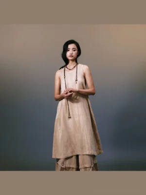 Front full-body view of khaki layered linen maxi dress with sleeveless A-line silhouette and flowing asymmetric hem