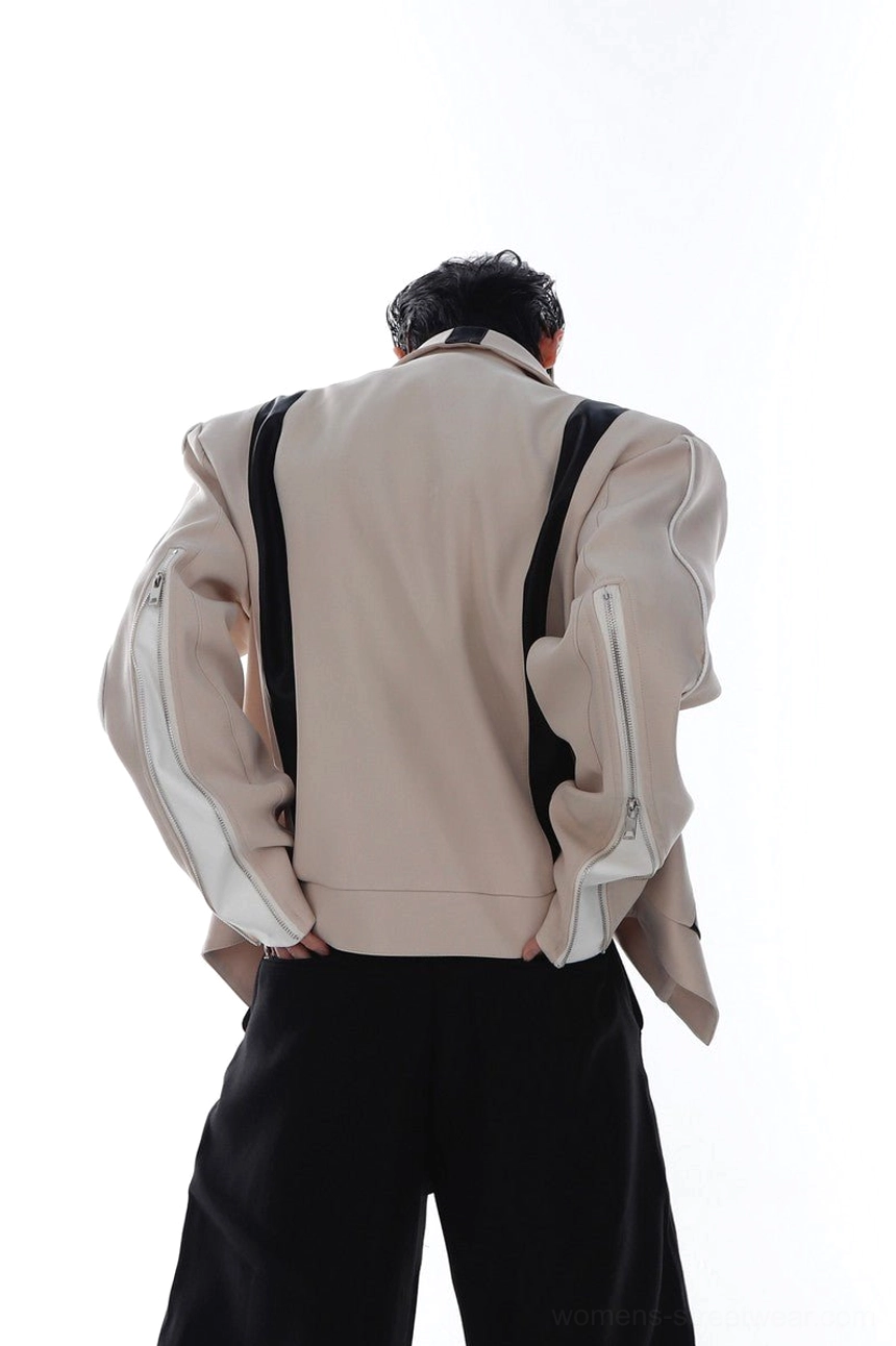Rear view of khaki layered biker jacket showing decorative back leather straps, solid khaki back panel, oversized fit, and zippered sleeve details