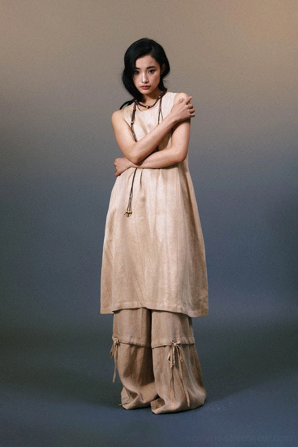 Front portrait of loose khaki layered linen maxi dress with natural crinkled texture and asymmetric hem