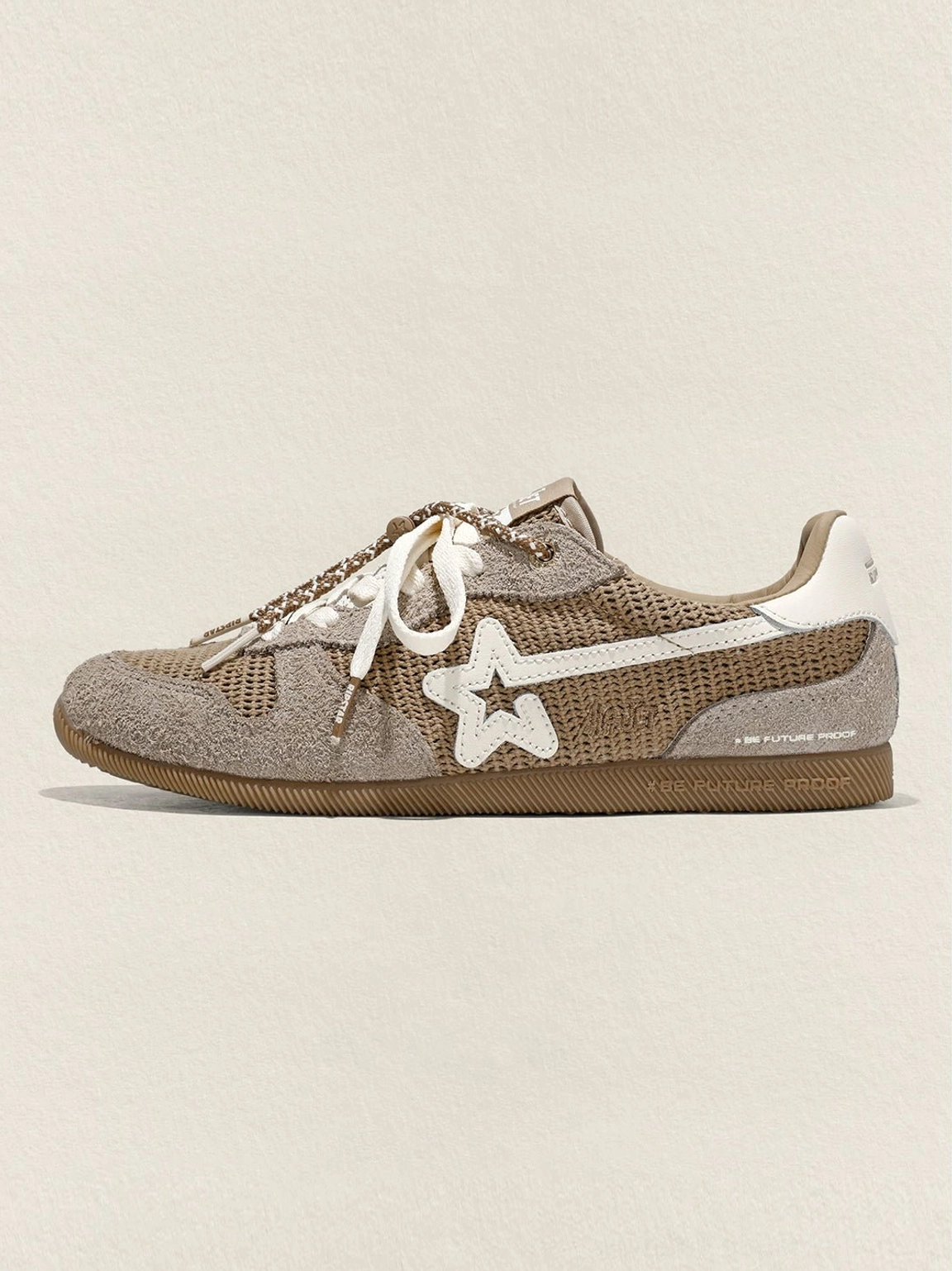 Side profile of a khaki mesh star German trainer sneaker with contrast star applique, decorative lace chain, and gum rubber sole