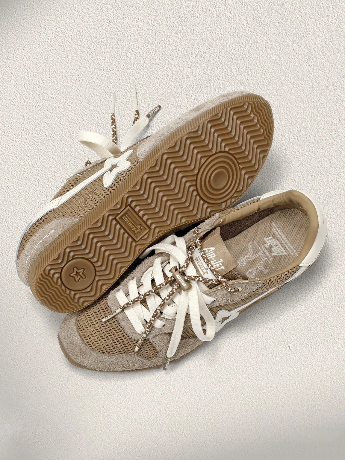 Top-down flat lay of khaki mesh star German trainer sneakers with star lace detail, branded insole, and wavy gum tread