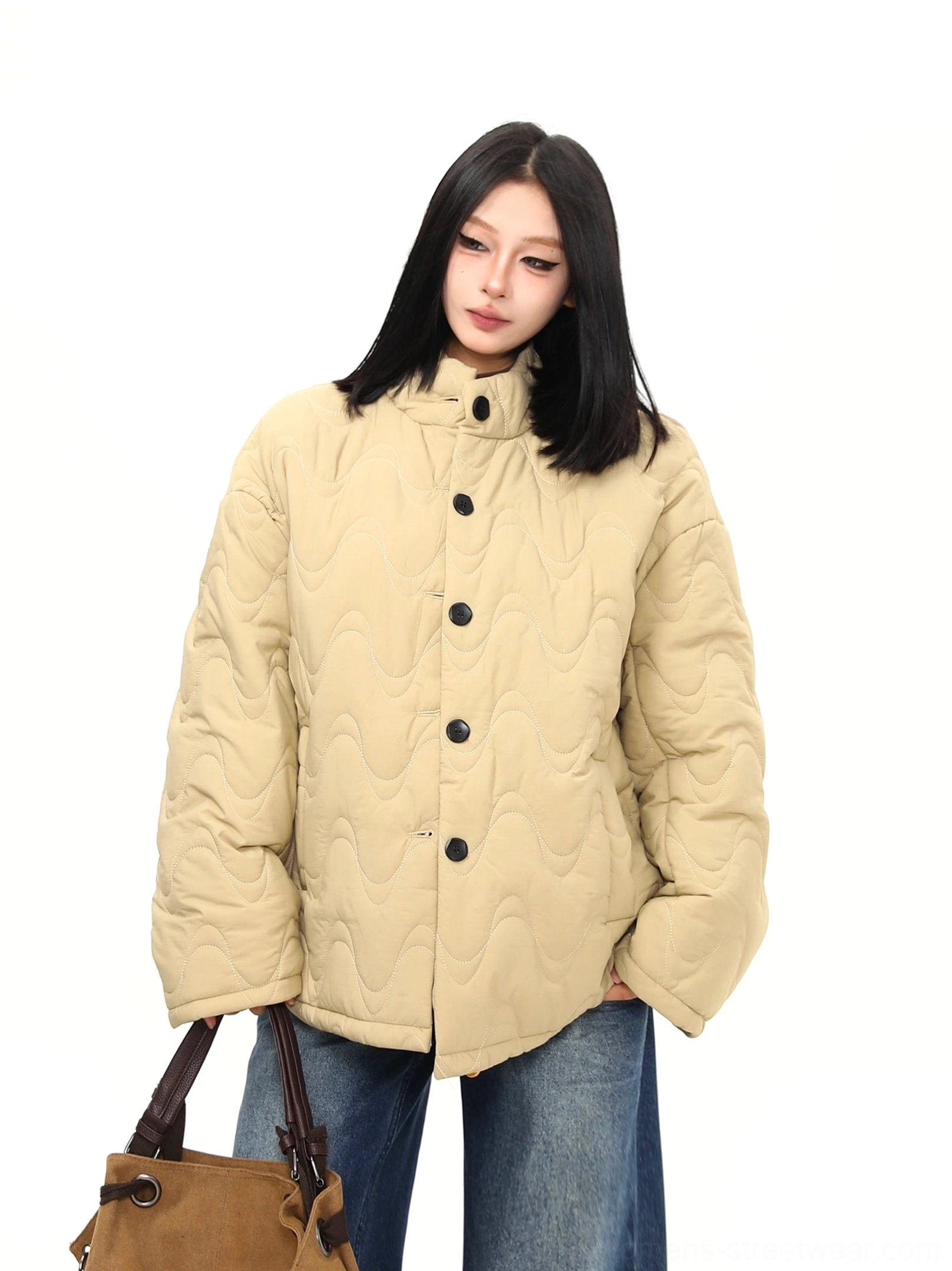 Close front view of khaki padded jacket with stand collar dark button closure and slanted hand pockets