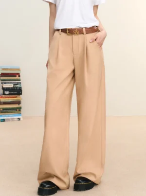 Khaki pleated wide-leg trousers styled with a white T-shirt and brown belt in a three-quarter streetwear outfit view