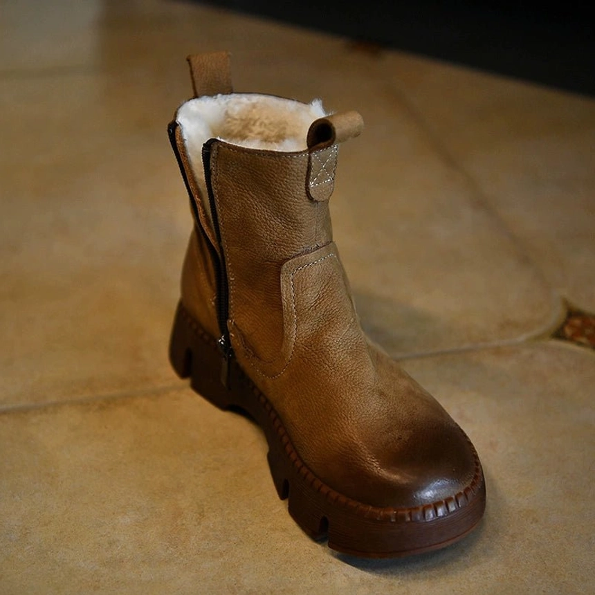 Khaki shearling-lined Chelsea-inspired winter boot with distressed leather upper, side zipper, thick platform lug sole, and warm fur cuff