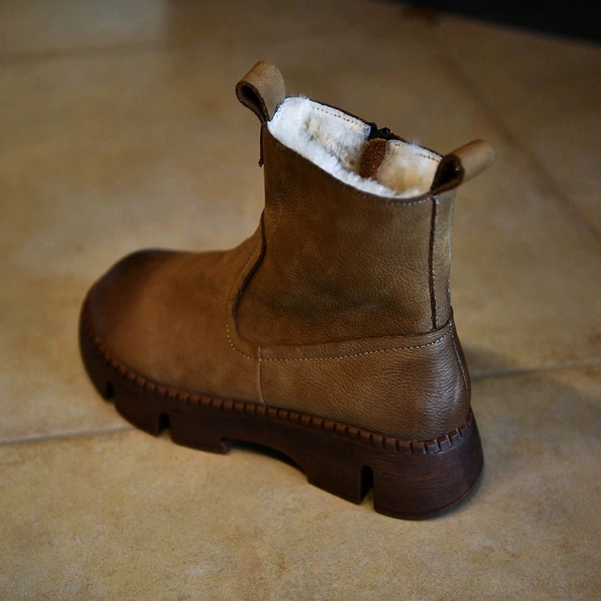 Rear three-quarter view of khaki shearling-lined winter platform boot with distressed leather upper, side zipper, warm lining, and thick lug sole