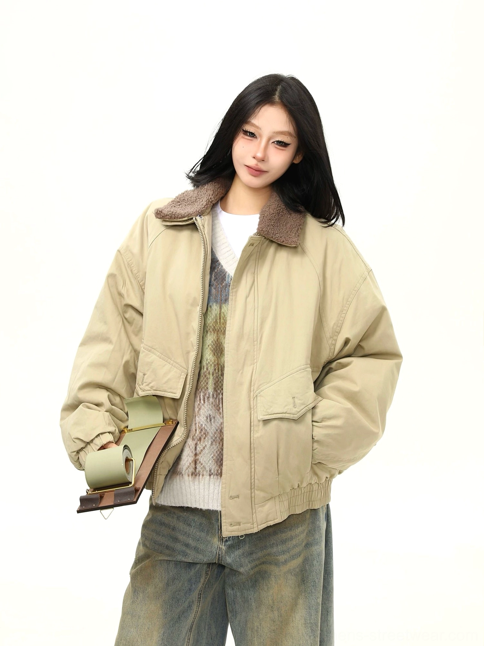 Women's khaki sherpa collar bomber jacket styled with layered knitwear, dual flap pockets, and casual winter streetwear accessories