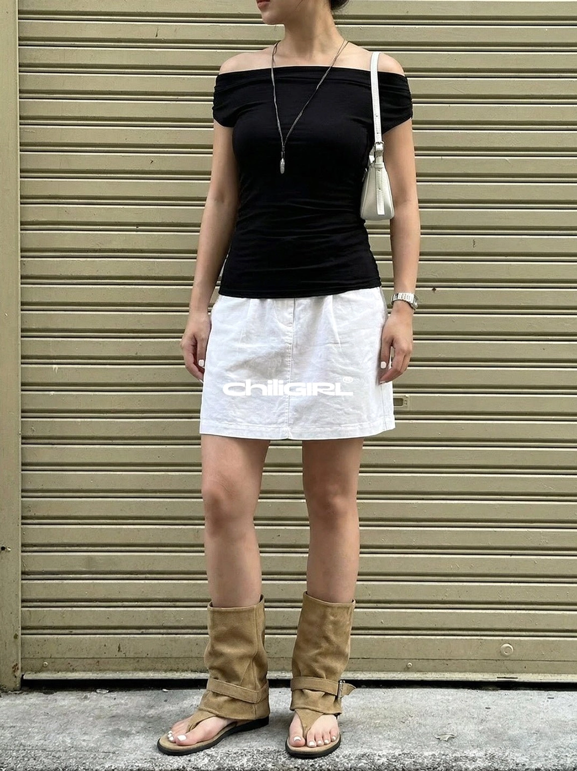 Khaki slouchy thong toe suede sandal ankle boots styled with black off shoulder top and white mini skirt