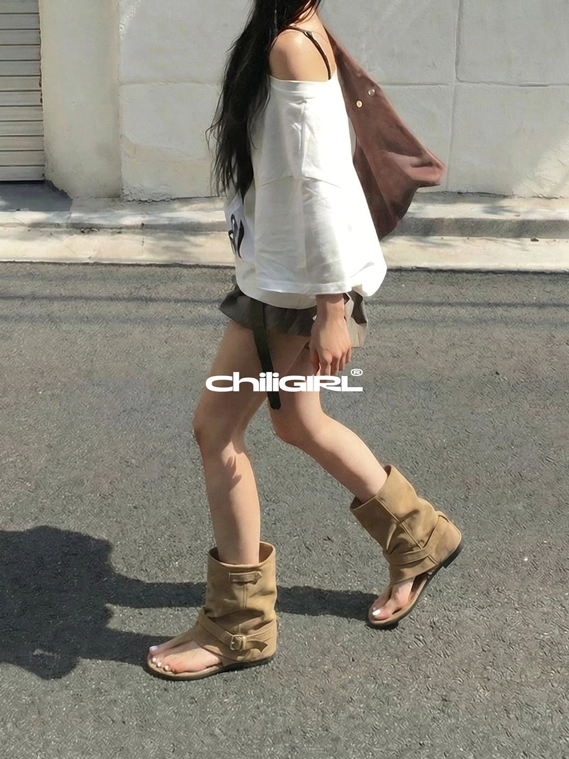 Khaki open toe slouchy suede sandal boots styled with off shoulder top and brown shorts on city street