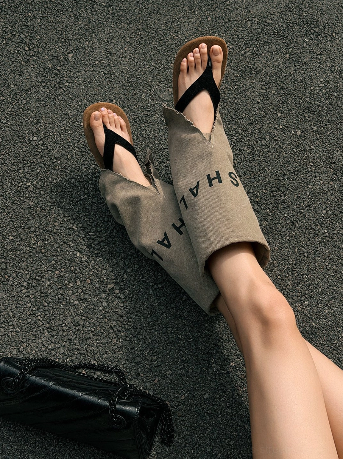 Close-up of khaki split-toe gladiator sandal boots with exposed ankle cutout, black toe-post strap, and printed shaft