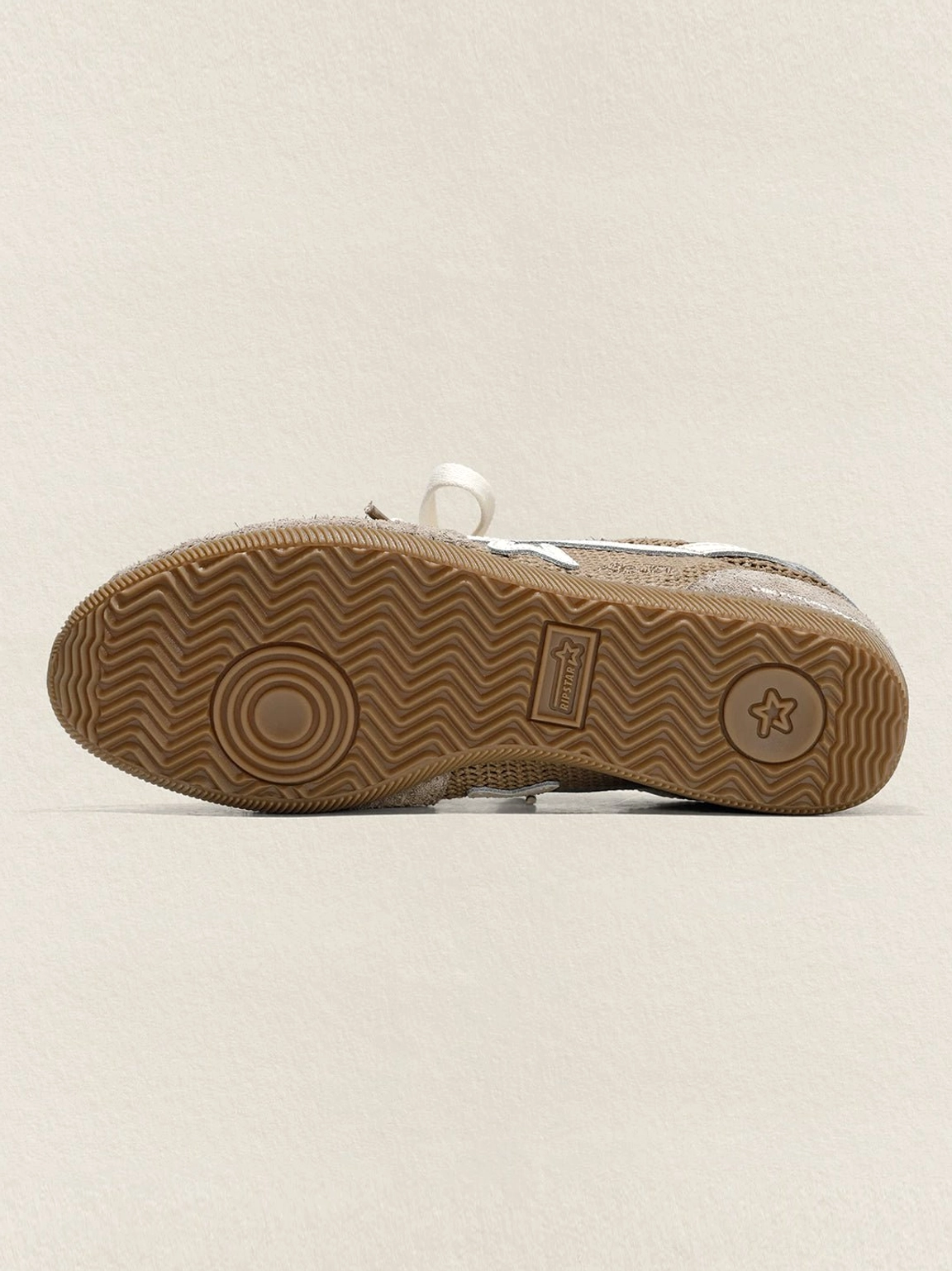 Bottom view of khaki star German trainer sneaker showing the textured wavy gum rubber outsole and tread pattern