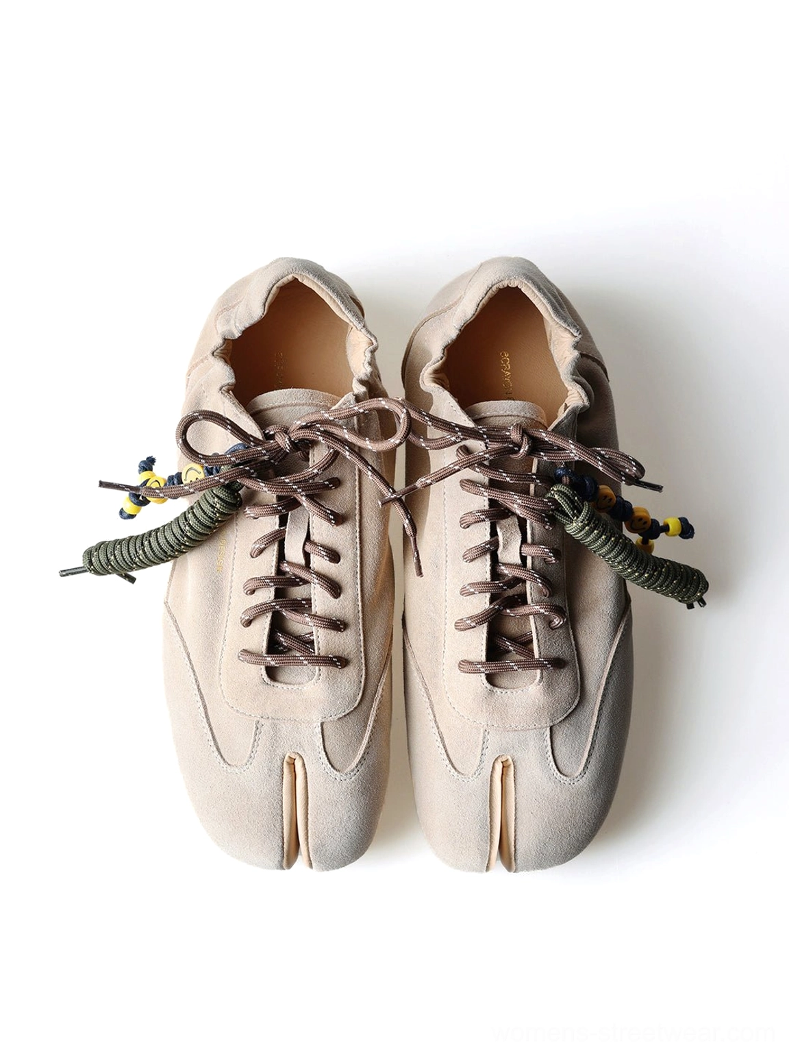 Front flat lay of khaki suede tabi sneakers with traditional inspired split toes and yellow black beaded laces