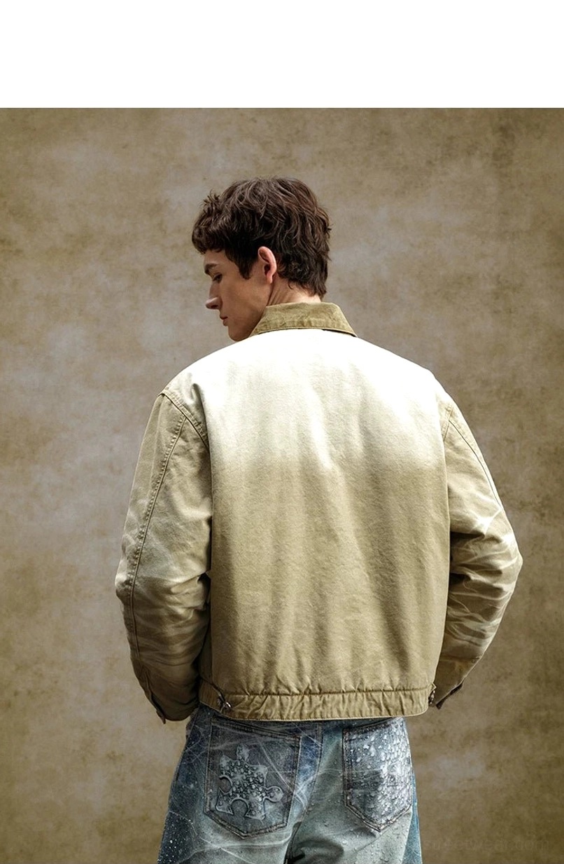 Back view of relaxed khaki embroidered toggle utility jacket showing clean silhouette, contrast collar, and lightly gathered hem