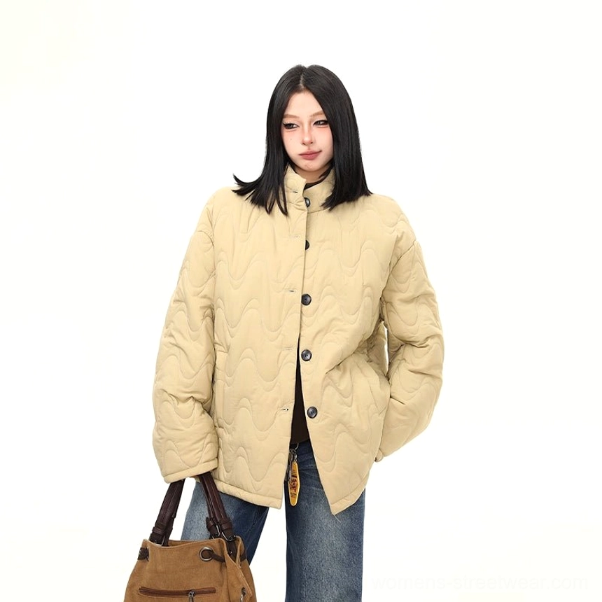 Khaki wavy quilted oversized jacket detail showing curved stitching relaxed silhouette and stand collar
