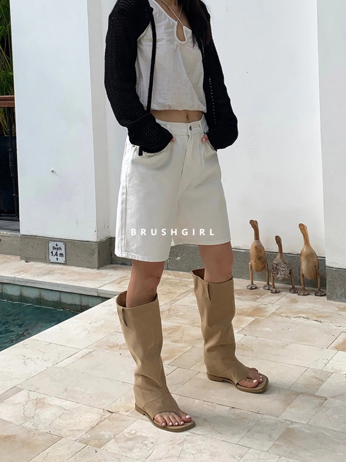 Full front outfit view featuring khaki western knee-high sandal boots, white shorts, and a black cardigan