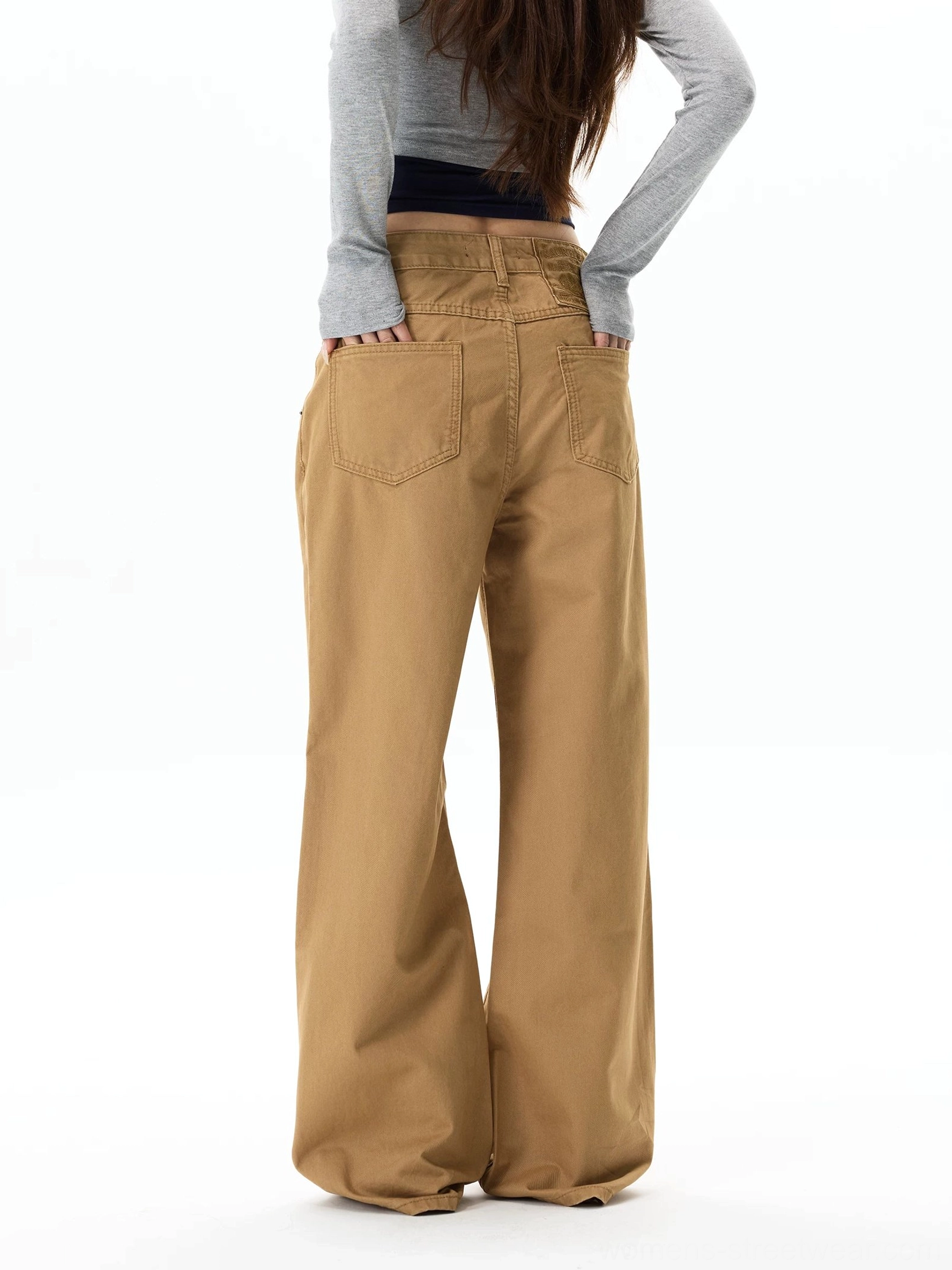 Back view of khaki wide-leg chino pants showing rear patch pockets, waistband detail, and relaxed streetwear silhouette
