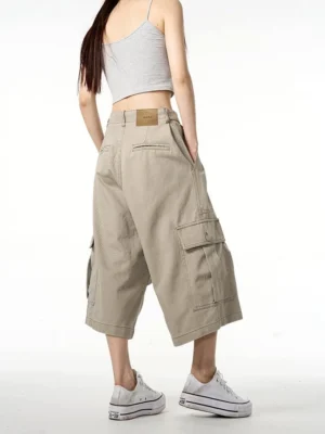 Back view of khaki wide-leg cropped cargo pants with rear pockets and waistband patch in relaxed Korean streetwear style