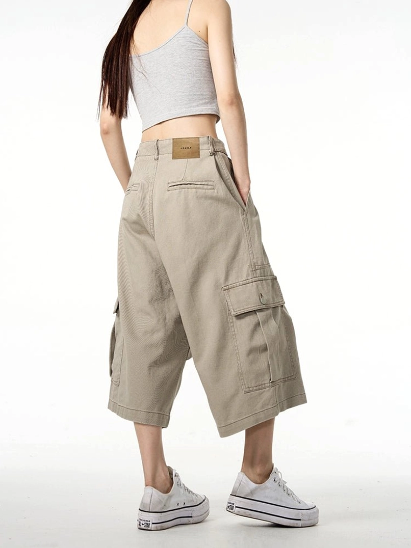 Back view of khaki wide-leg cropped cargo pants with rear pockets and waistband patch in relaxed Korean streetwear style