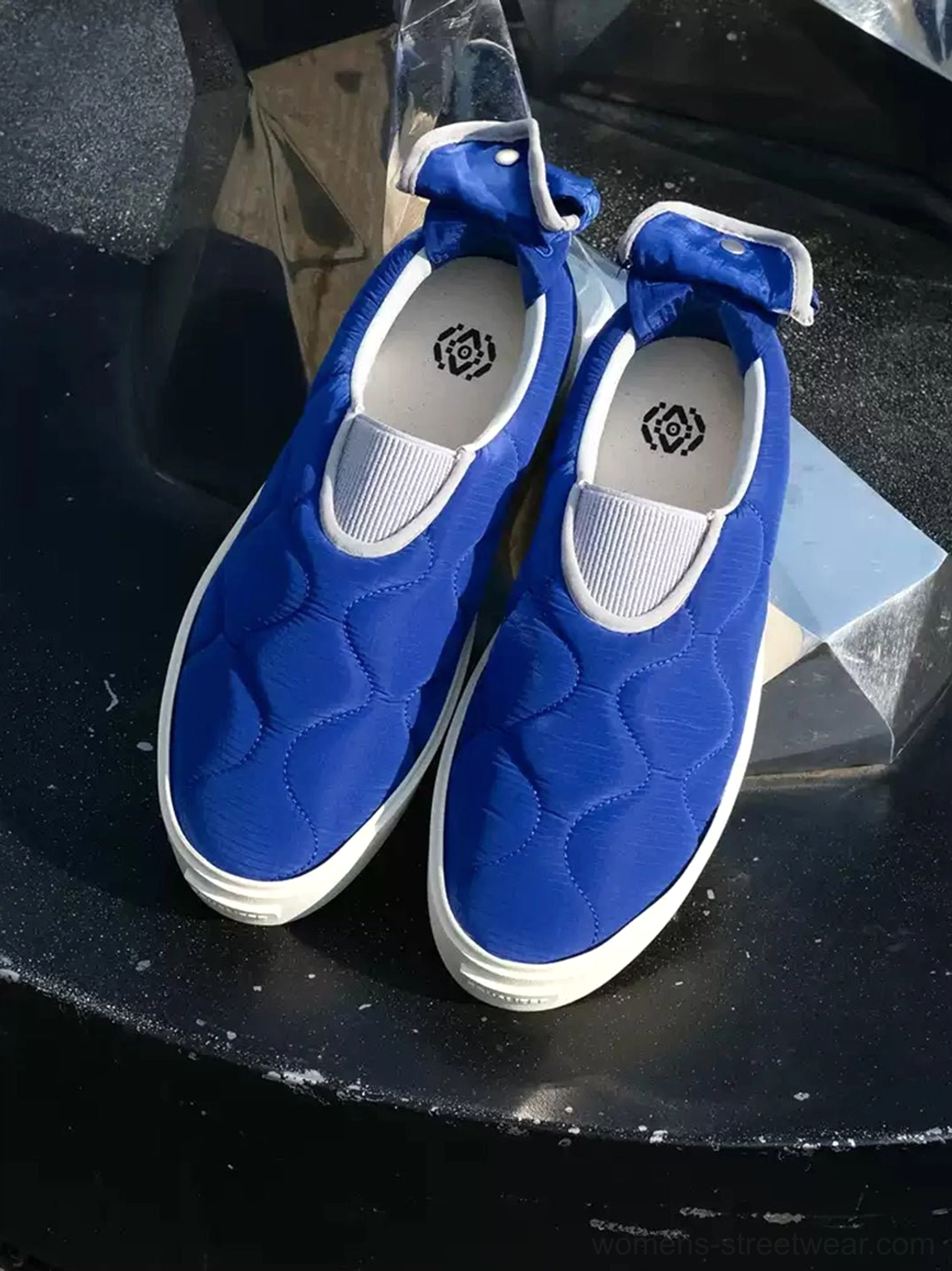 Pair of Klein blue quilted slip-on skate shoes with padded textile uppers displayed from above