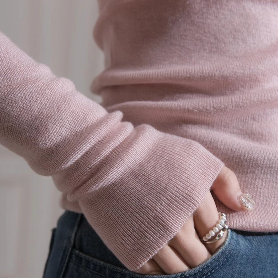 Korean fashion dusty pink long sleeve knit top with soft blush color and sculptural bust twist