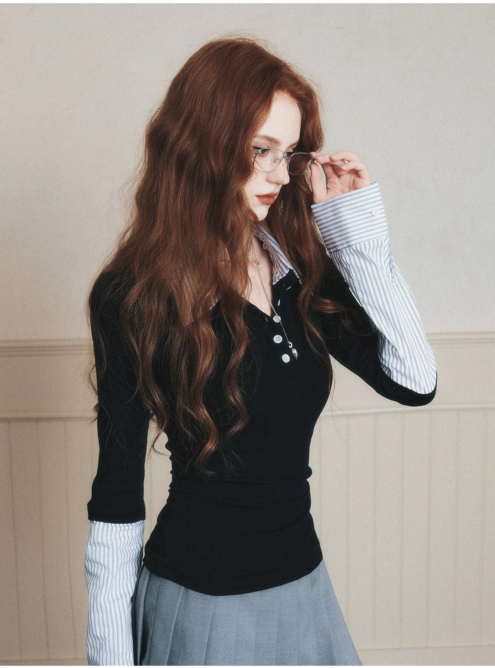 Korean inspired black layered polo top with striped collar and cuffs styled with a grey pleated mini skirt