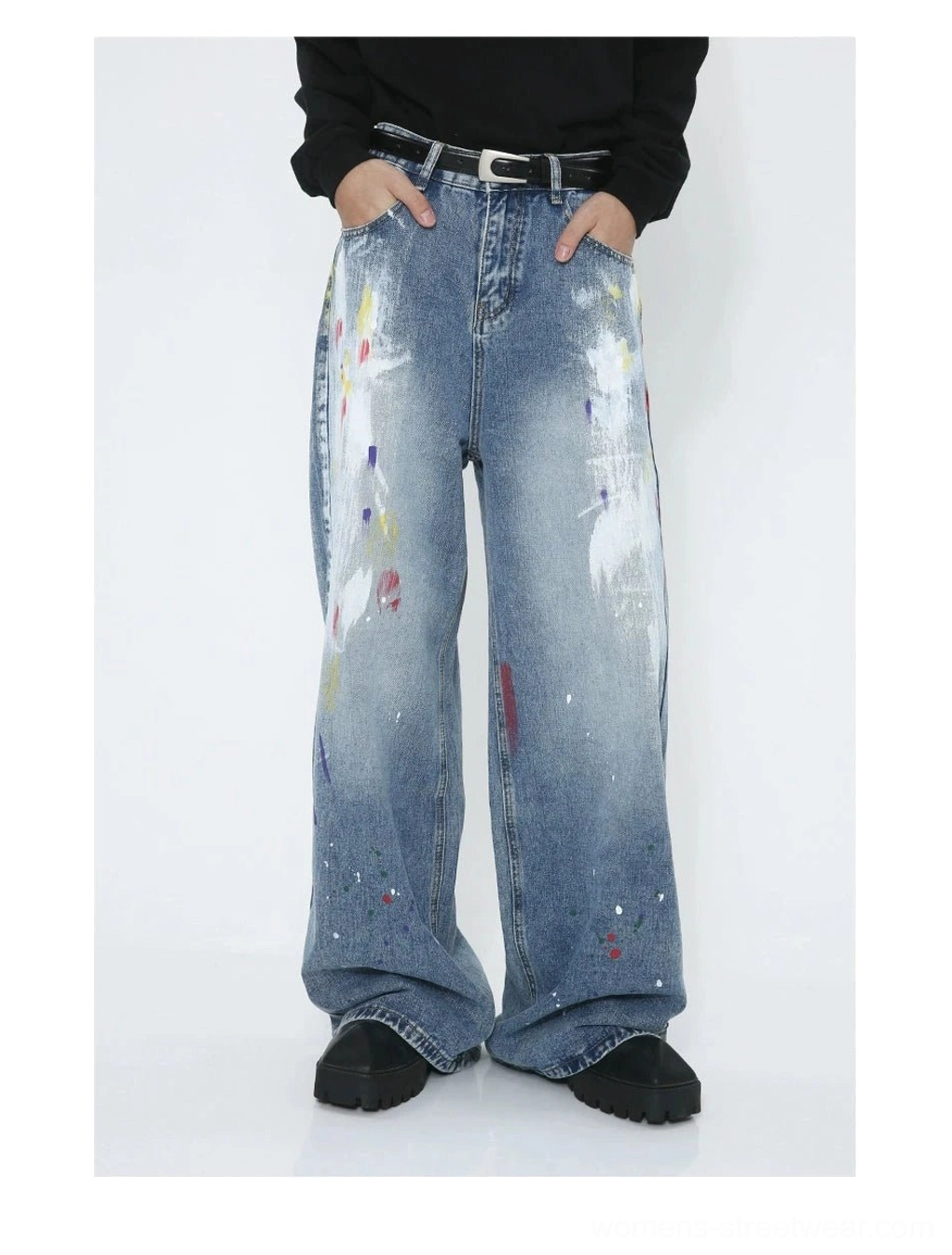 Contemporary Korean-inspired wide-leg jeans in faded blue denim with bold multicolor graffiti paint details and relaxed proportions
