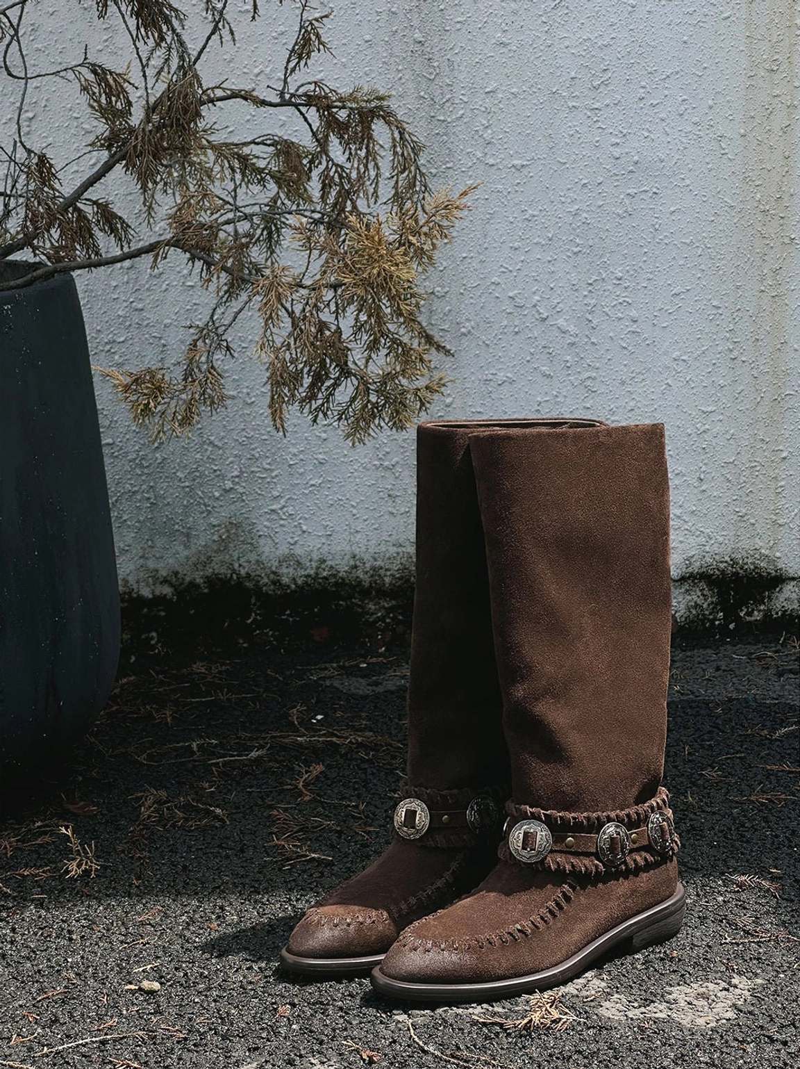 Korean-inspired women's suede western knee-high boots with relaxed shafts, buckle hardware, pointed toes, and earthy colors