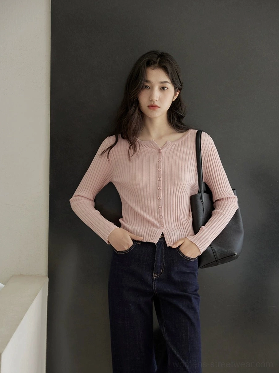 Dusty pink ribbed knit button-up slim fit cardigan for women paired with dark denim jeans