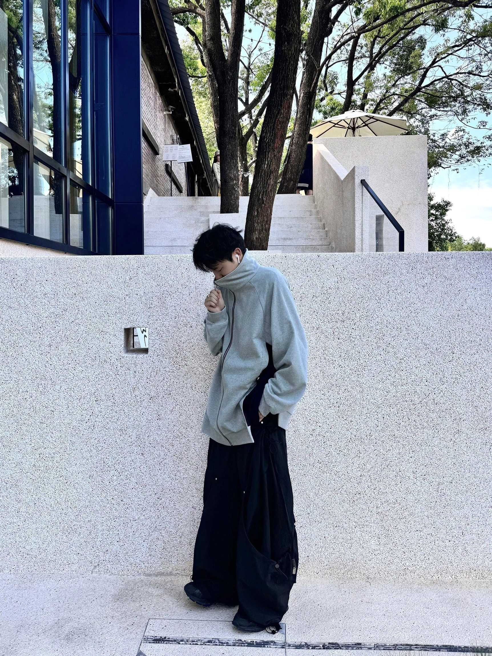 Modern Korean street fashion outfit featuring wide leg technical pants and practical cargo pocket styling
