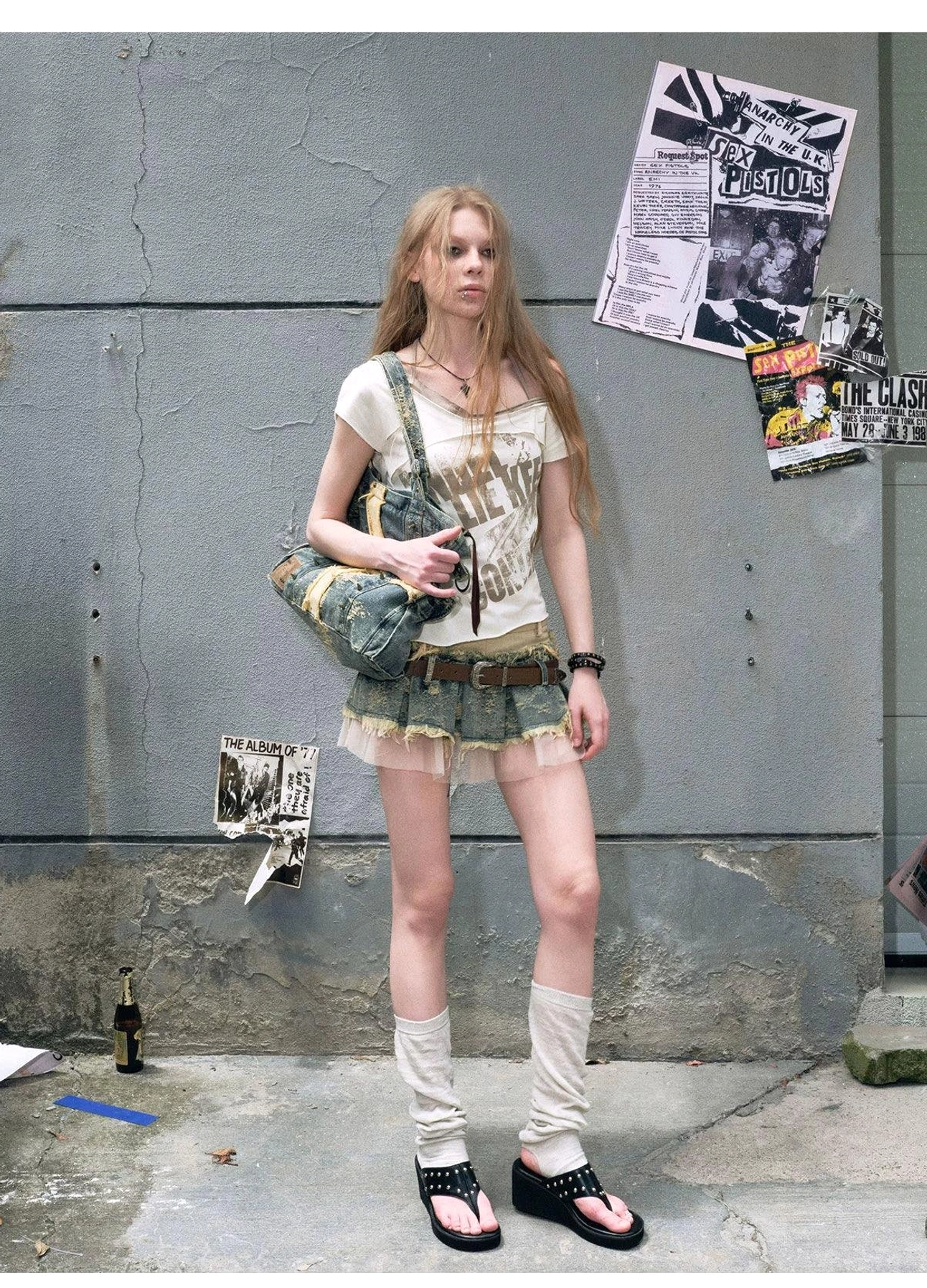 Full body Korean streetwear styling with a distressed layered denim mini skirt, brown belt, sheer tulle hem, denim shoulder bag, and knee-high socks
