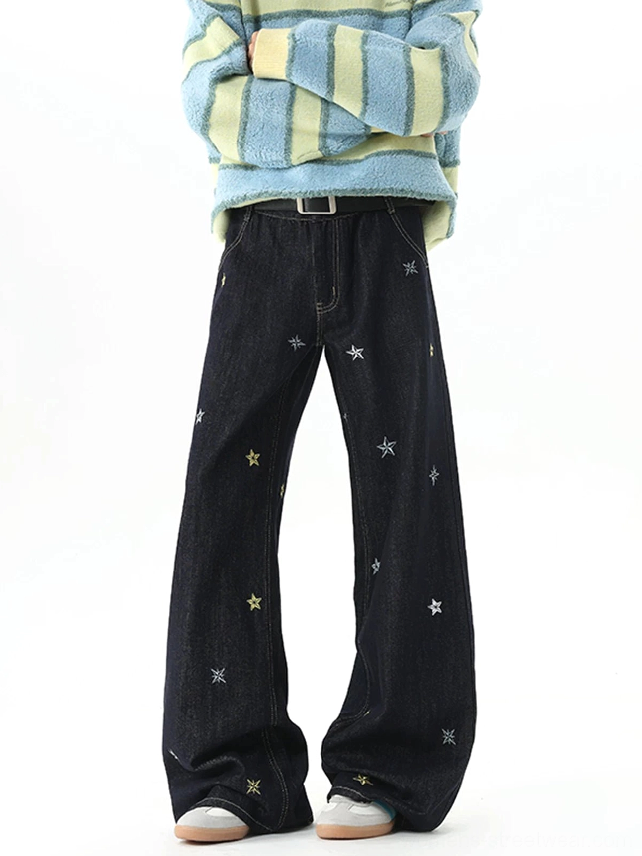 Front three-quarter view of dark indigo Korean streetwear wide-leg jeans with star embroidery and black leather belt