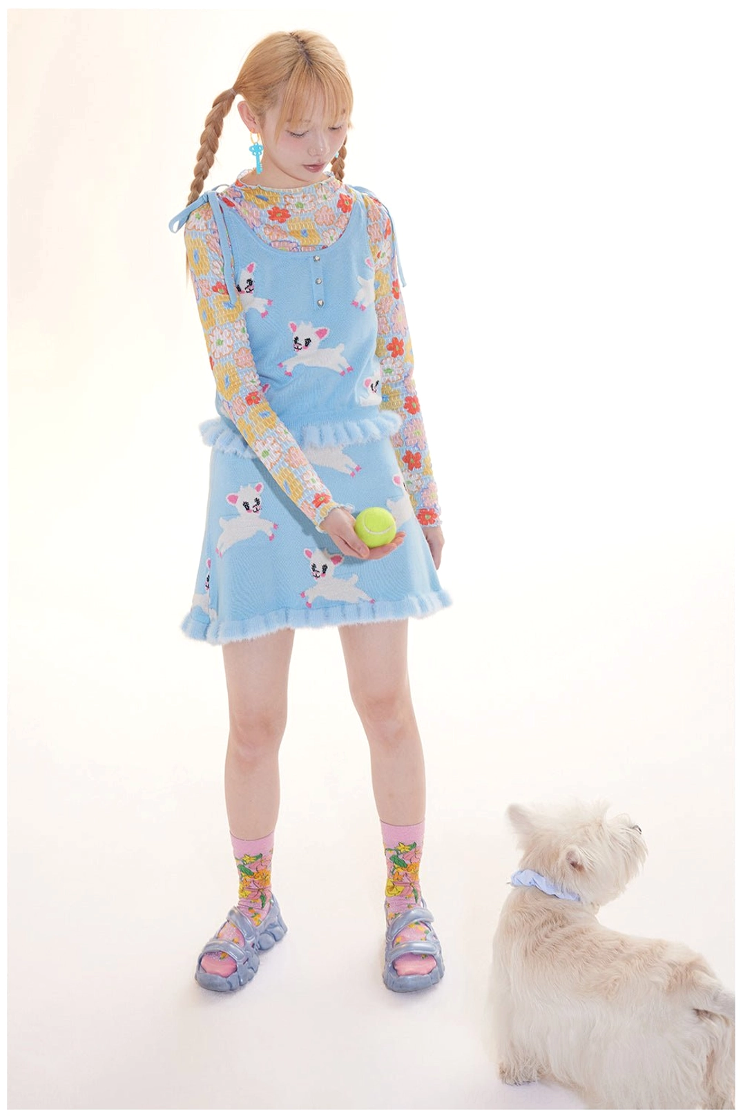 Full styled outfit featuring a lamb print knit cami and ruffle mini skirt with colorful socks and layered streetwear