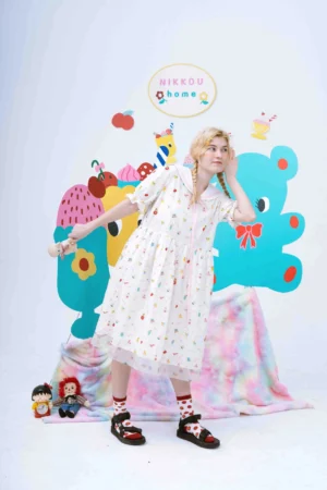 Three-quarter view of a playful Korean style cartoon printed babydoll dress with pink sailor collar trim and ruffled short sleeves