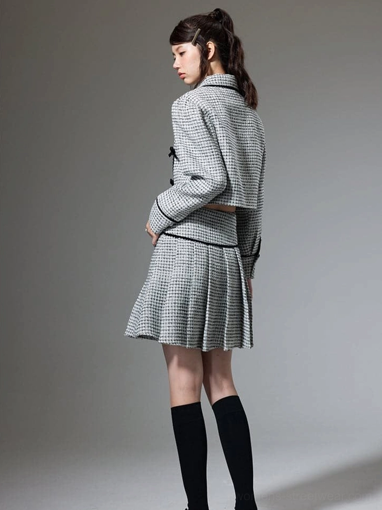 Korean style cropped jacket and pleated mini skirt with tailored texture and graphic bow appliques