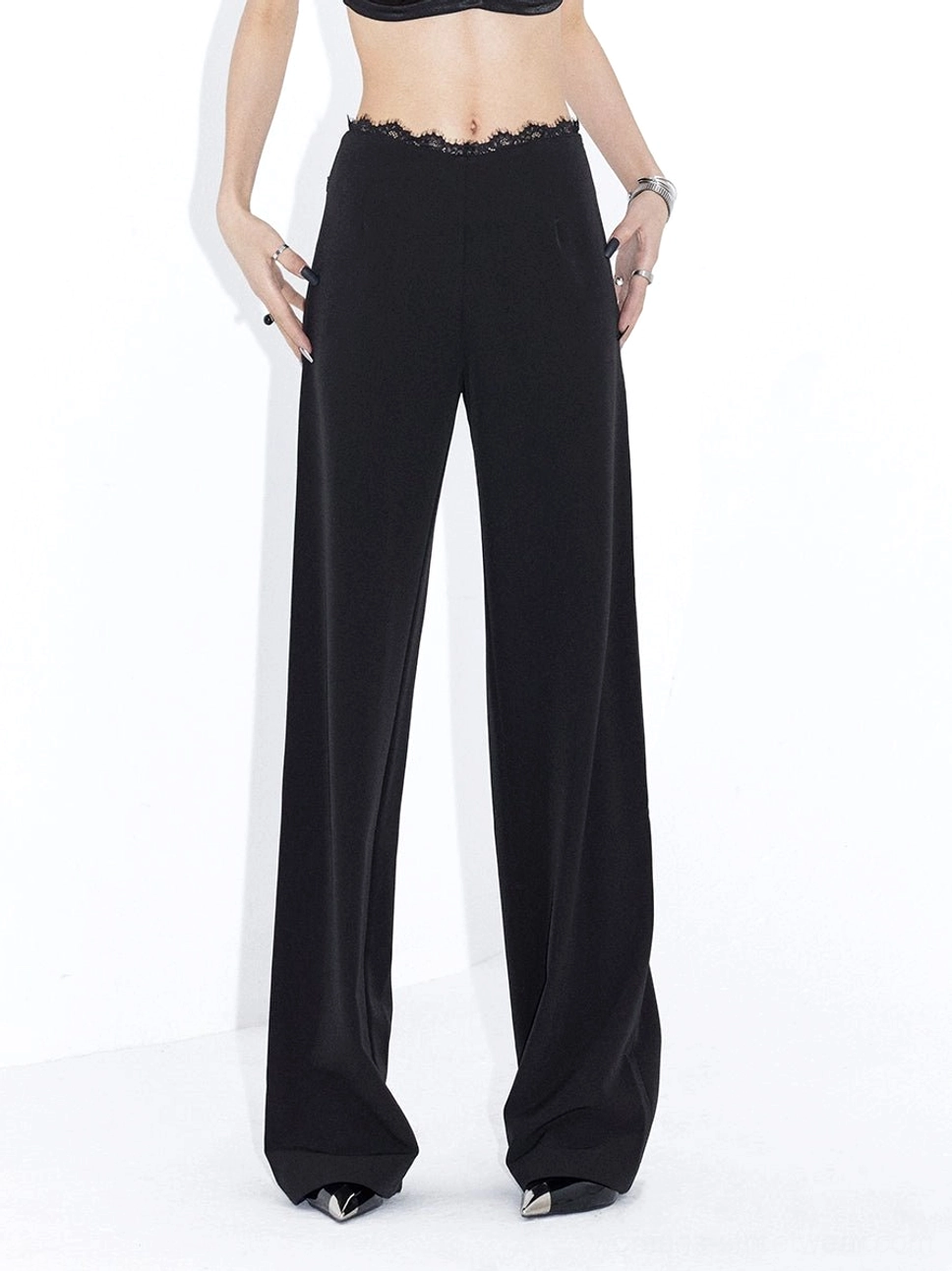Black scalloped lace waistband and flowing wide-leg streetwear trousers front detail