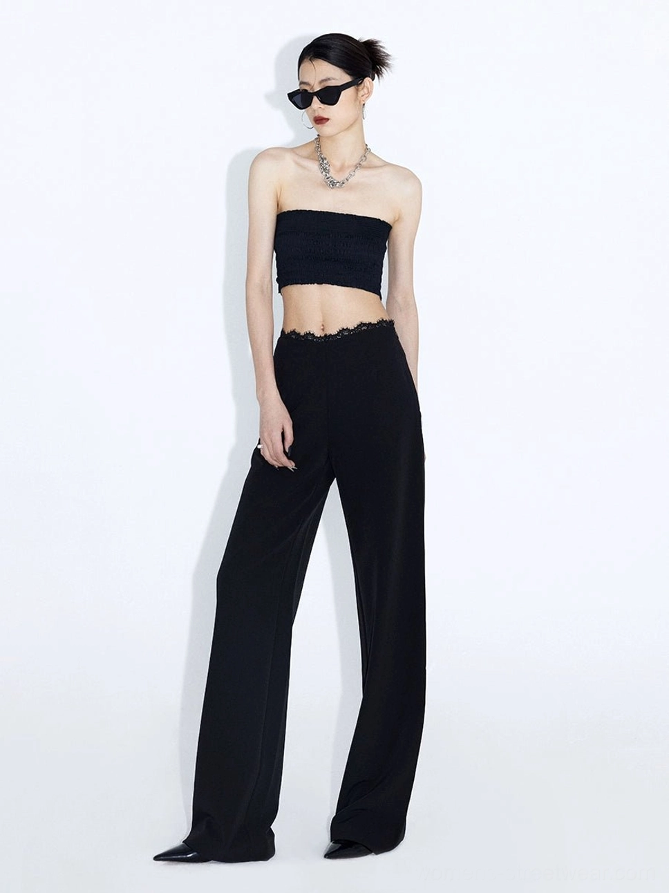 Black lace waist wide-leg streetwear trousers styled with strapless crop top and sunglasses