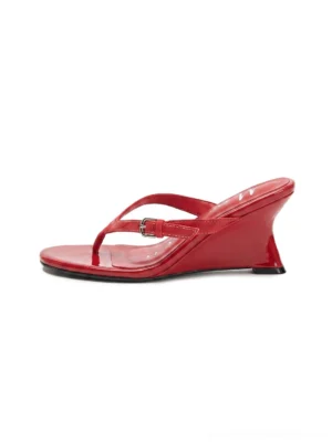 Red lambskin thong kitten heel sandals with rounded open toe and slim low heel shown from the front side on a clean white background