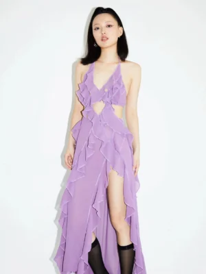 Front full-body view of a lavender halter ruffle cutout maxi dress with sheer chiffon fabric, waist cutouts, layered ruffles, and high side slit