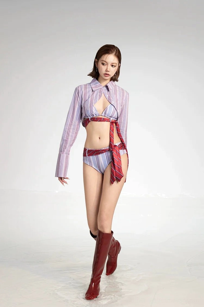 Lavender striped bikini and cropped cover-up set with red tie accents shown in a front walking studio view