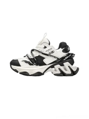 Black and white layered chunky dad sneakers with dual laces and sculpted platform sole left front view