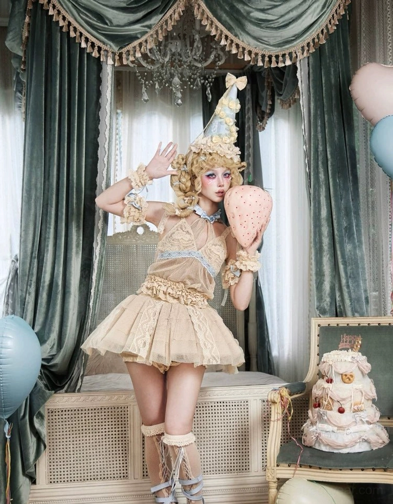 Beige layered lace tulle mini skirt paired with a structured corset top in a romantic vintage lolita fashion ensemble